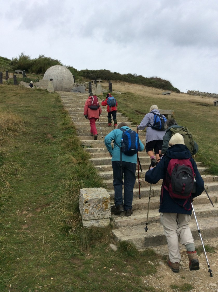 Group climbing up to the Globe at Durlston Country Park