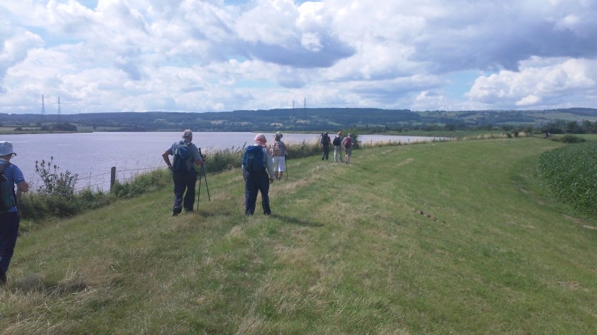 Group walking alongside river Severn (now at high tide) near end of the walk