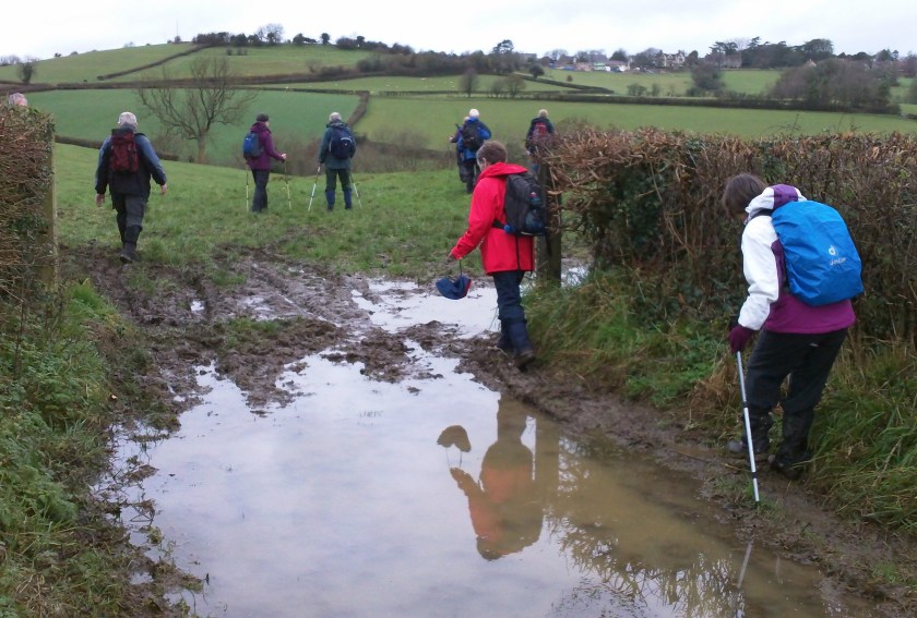 Jean and Alison carefully negotiate a very muddy farm gate. Note that Alison is modelling the novel one boot/one shoe footwear combo!
