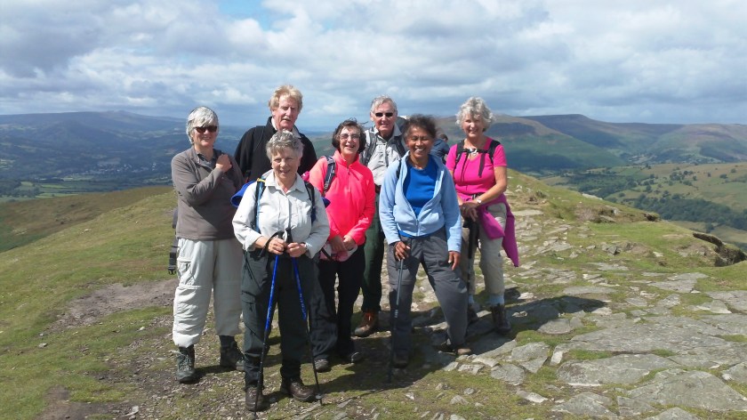 Group posing in the sunshine feeling pleased with themselves for reaching the top!