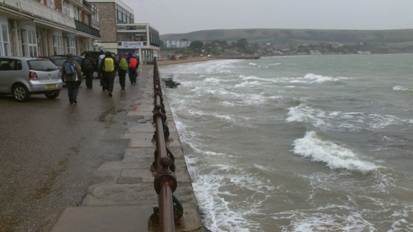 Waling along the Swanage sea front (now in wet weather gear !) at end of walk.