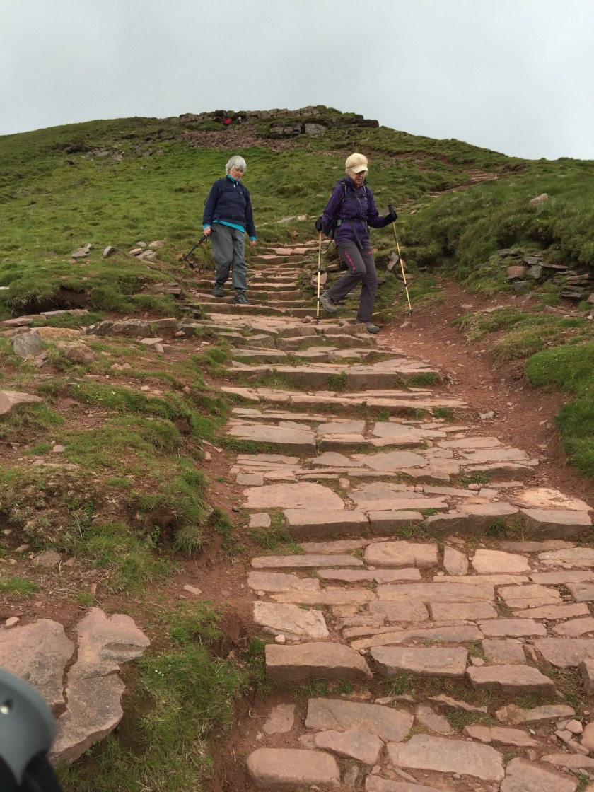 Liz and Gill start the descent from the top of Pen y Fan.