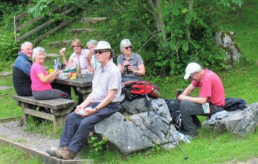 Group having their well earned lunch break after a strenuous morning's walking