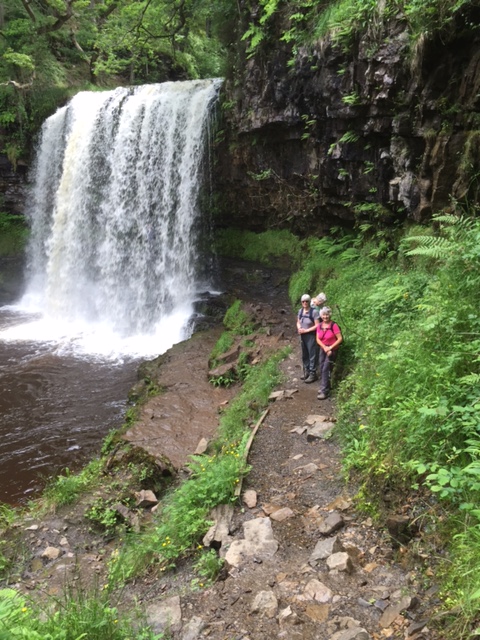Gill and Wendy appear from behind the Waterfall