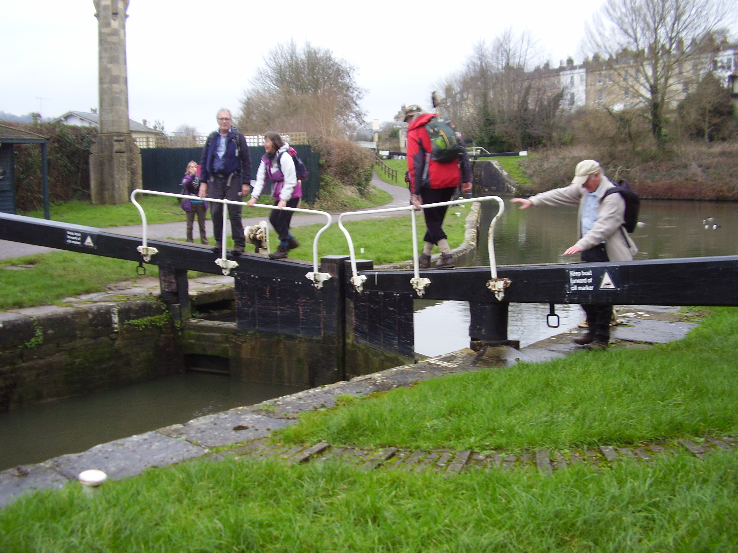 Group crossing the canal lock bridge near Bath
