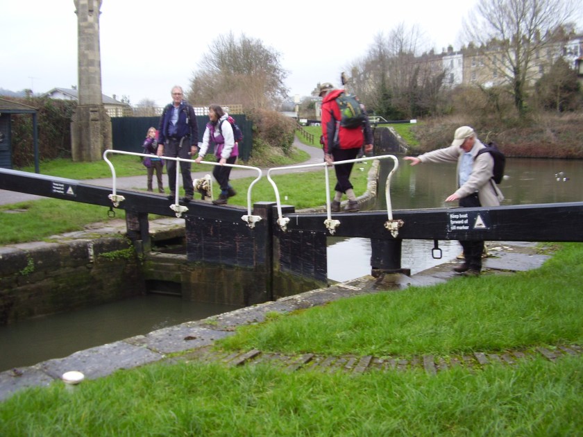 Group crossing the canal lock bridge near Bath